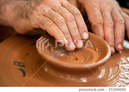 Potter makes pottery dishes on potter's wheel 55300000