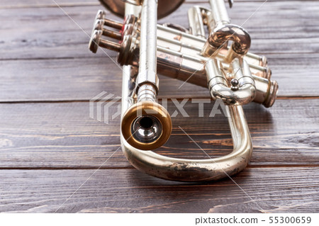 Trumpet on wooden background. Trumpet on wooden background. 55300659