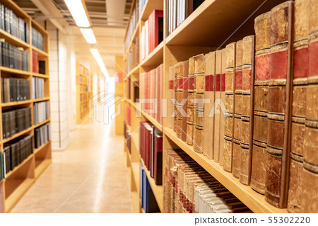 Antique books on wooden bookshelf in library Antique books on wooden bookshelf in library 55302220
