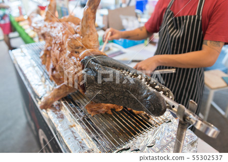 Fried crocodile meat on the barbeque. Street food Fried crocodile meat on the barbeque. Street food 55302537