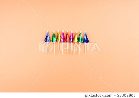 Rainbow neon cocktail umbrellas on orange Rainbow neon cocktail umbrellas on orange 55302905