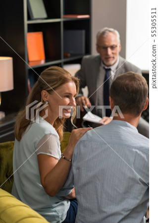 Blonde woman smiling and looking at her husband 55305511