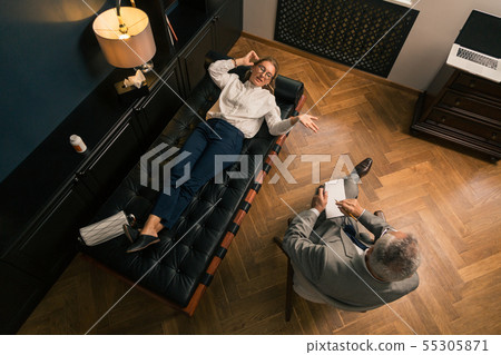 Woman talking to her psychotherapist in his office 55305871