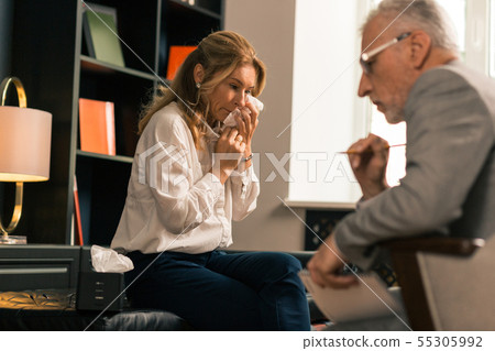 Upset depressed blonde woman complaining to her psychologist Upset depressed blonde woman complaining to her psychologist 55305992