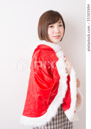 A woman in Santa costume A woman in Santa costume 55305994
