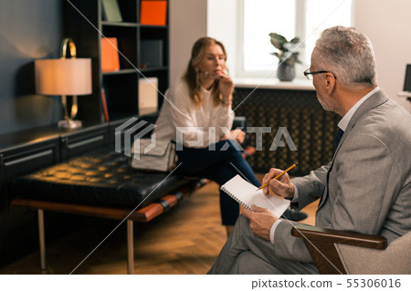 Thoughtful sad woman sitting in her psychoanalysts office Thoughtful sad woman sitting in her psychoanalysts office 55306016