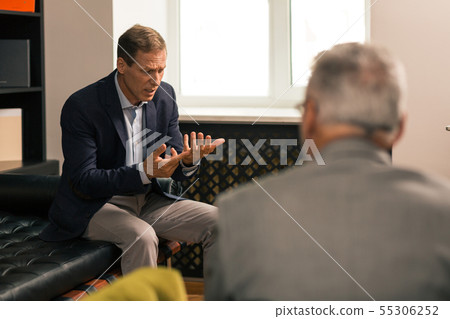 Upset married brown-haired man discussing his personal problems 55306252