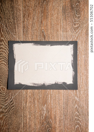 Black painted frame on white paper on wooden Black painted frame on white paper on wooden 55306702