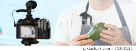 Man Vlogger Showing Ripe Tropical Avocado Fruit 55308125