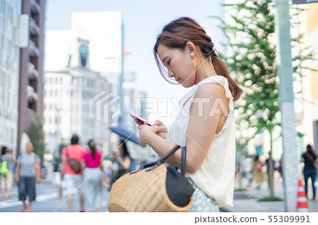 A woman shopping in Ginza, a pedestrian paradise for holidays A woman shopping in Ginza, a pedestrian paradise for holidays 55309991
