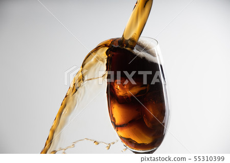 Iced coffee overflowing from glass Iced coffee overflowing from glass 55310399