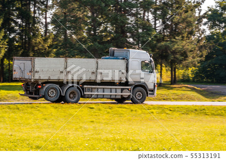 Big dump truck on country road Big dump truck on country road 55313191