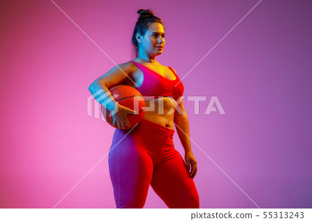 Young caucasian plus size female model's training on gradient background 55313243
