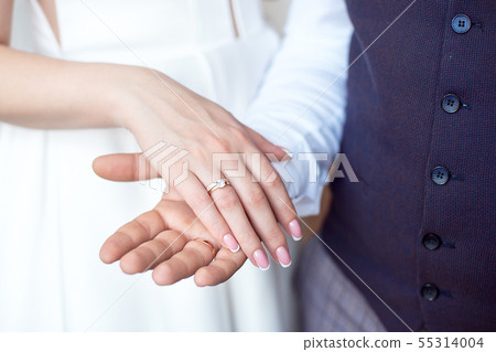 Wedding photo couple holding hands in hands wedding rings Wedding photo couple holding hands in hands wedding rings 55314004