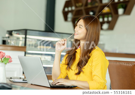 woman working with laptop in cafe 55316181