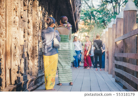 Female tourist take a photo at Shwe Nan Daw Kyaung Female tourist take a photo at Shwe Nan Daw Kyaung 55318179