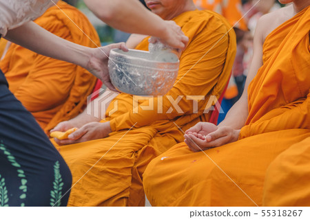 People pouring water to Buddhist Monk People pouring water to Buddhist Monk 55318267