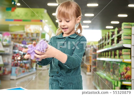 Happy girl playing with kinetic sand in playing room. Happy girl playing with kinetic sand in playing room. 55320879