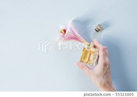 Luxury bottle of perfume with fresh lily flowers Luxury bottle of perfume with fresh lily flowers 55321005