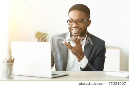 African Man Using Voice Assistant On Cellphone African Man Using Voice Assistant On Cellphone 55321007