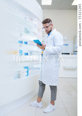 Handsome brunette male person doing pills inventory Handsome brunette male person doing pills inventory 55321265