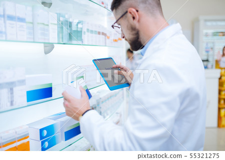 Serious brunette chemist searching information about pills Serious brunette chemist searching information about pills 55321275