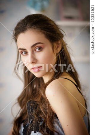 Portrait of beautiful young woman standing at 55321625