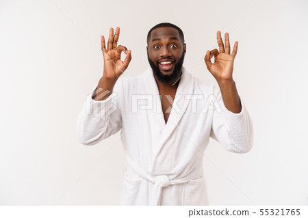 Young African man in bathrobe prepare for skin care showing ok finger sign. Human emotions concept Young African man in bathrobe prepare for skin care showing ok finger sign. Human emotions concept 55321765