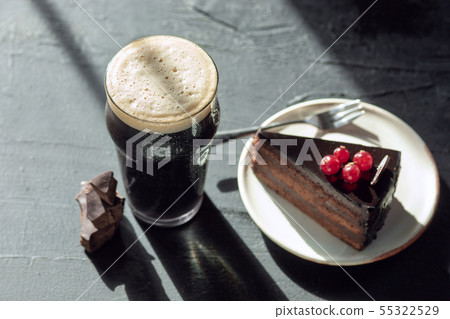 Glass of dark beer on the stone table background 55322529