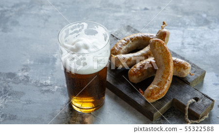 Glass of beer on white stone background Glass of beer on white stone background 55322588