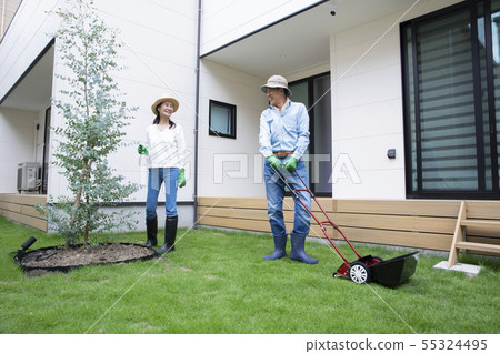 Lawn mower garden work couple Lawn mower garden work couple 55324495