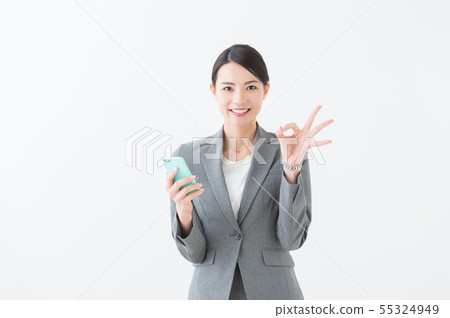 Woman with a smartphone (grey suit) Woman with a smartphone (grey suit) 55324949