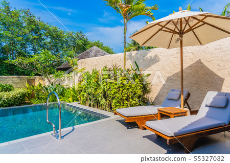Umbrella and chair around swimming pool neary sea ocean beach with blue sky and white cloud 55327082