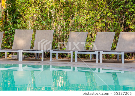 Empty chair around swimming pool in hotel resort 55327205