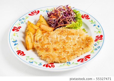 schnitzel and fried potatoes on plate 55327471