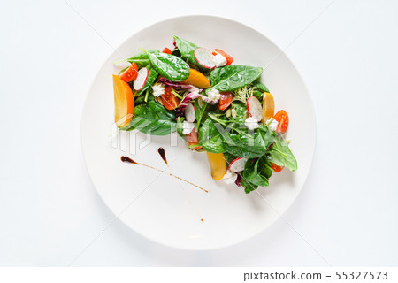 salad with spinach and persimmon on the white plate 55327573
