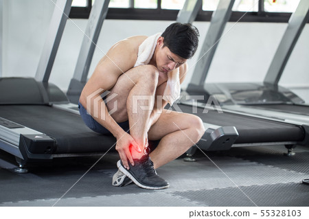Asian man injury ankle pain after training running 55328103