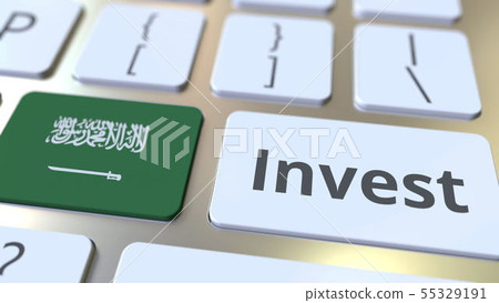 INVEST text and flag of Saudi Arabia on the buttons on the computer keyboard. Business related 55329191