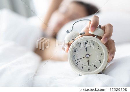 Closeup woman sleeping on bed and hand holding 55329208