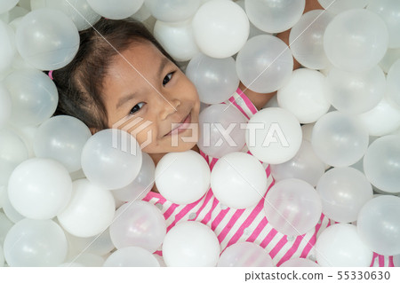 asian child girl play with white plastic balls 55330630