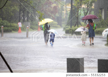 People walking with umbrellas in the rain 55332253
