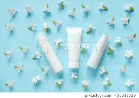 White flowers and three cosmetic, medical white tube, bottle for cream, ointment, toothpaste or 55332529