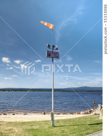 Ferry pier with windsock at the shore of Lipno 55333098