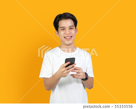 Young smiling Asian man with holding smart phone 55333556