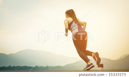 Selective focus of young woman runner on the road 55333573
