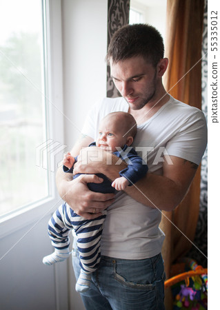 Father holding his little baby at home 55335012