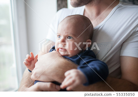 Cute little baby closeup holding by dad 55335050