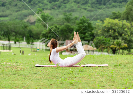 woman practice yoga bow or dhanurasana pose woman practice yoga bow or dhanurasana pose 55335652