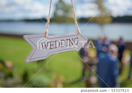 Wooden direction with wedding text is hanging near Wooden direction with wedding text is hanging near 55337813