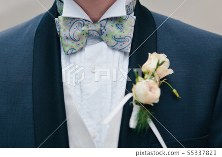 Close-up pink roses boutonniere with the decor on 55337821